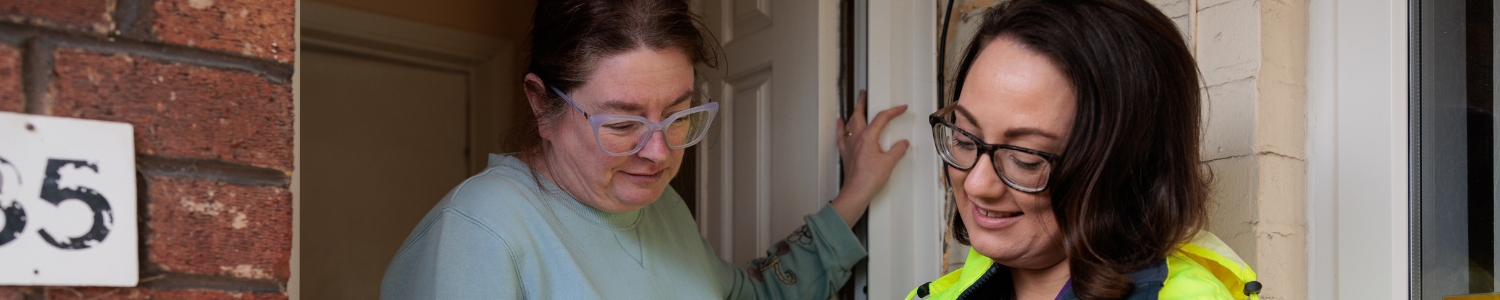 two people talking at the door step