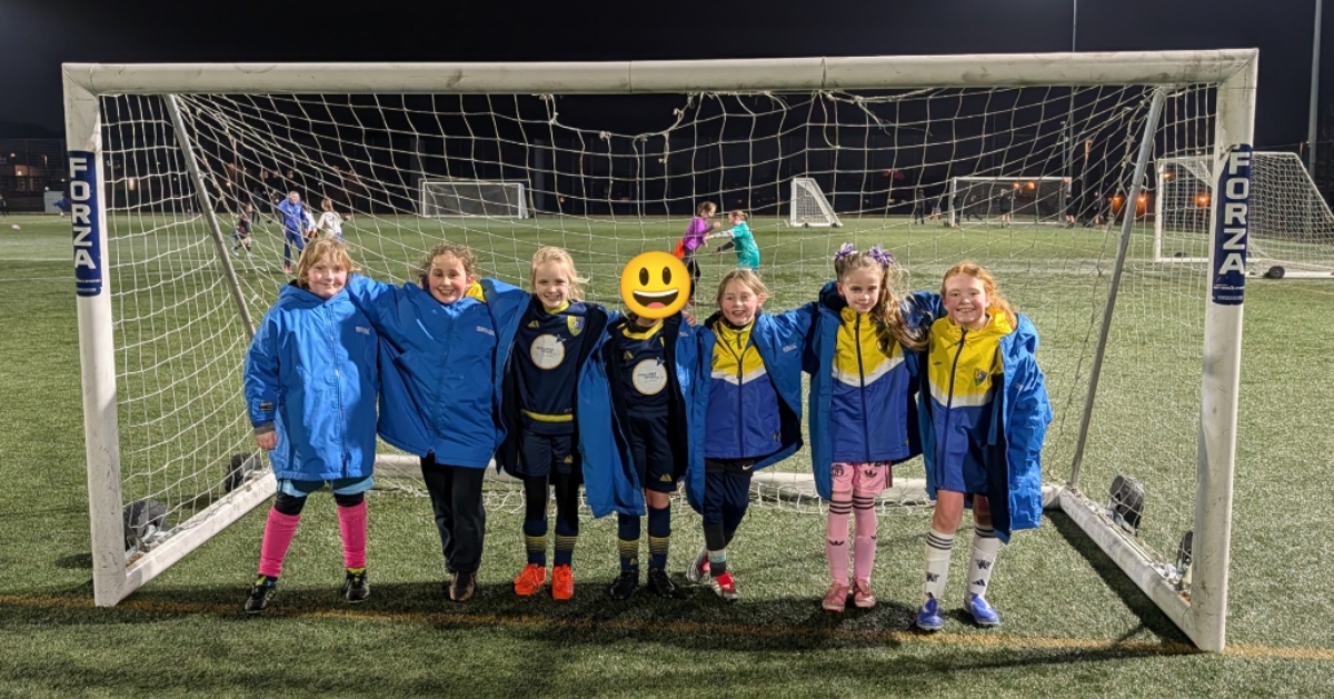 a football team infront of a goal