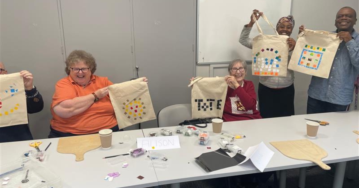 participants in a class showing their creations