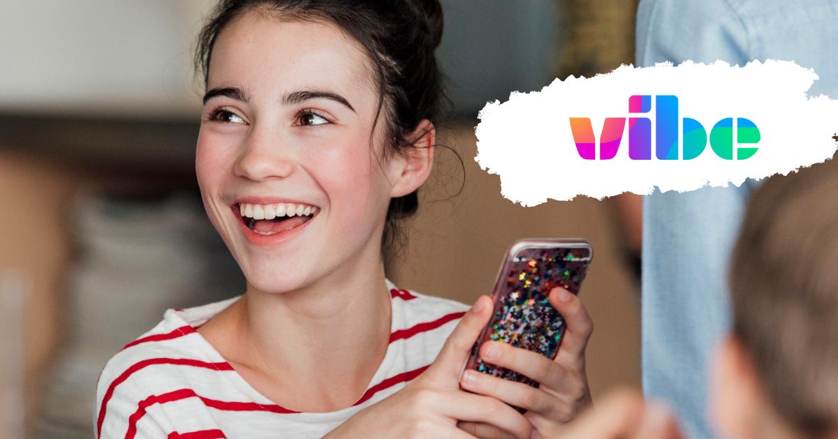 Young girl smiling and holding her phone