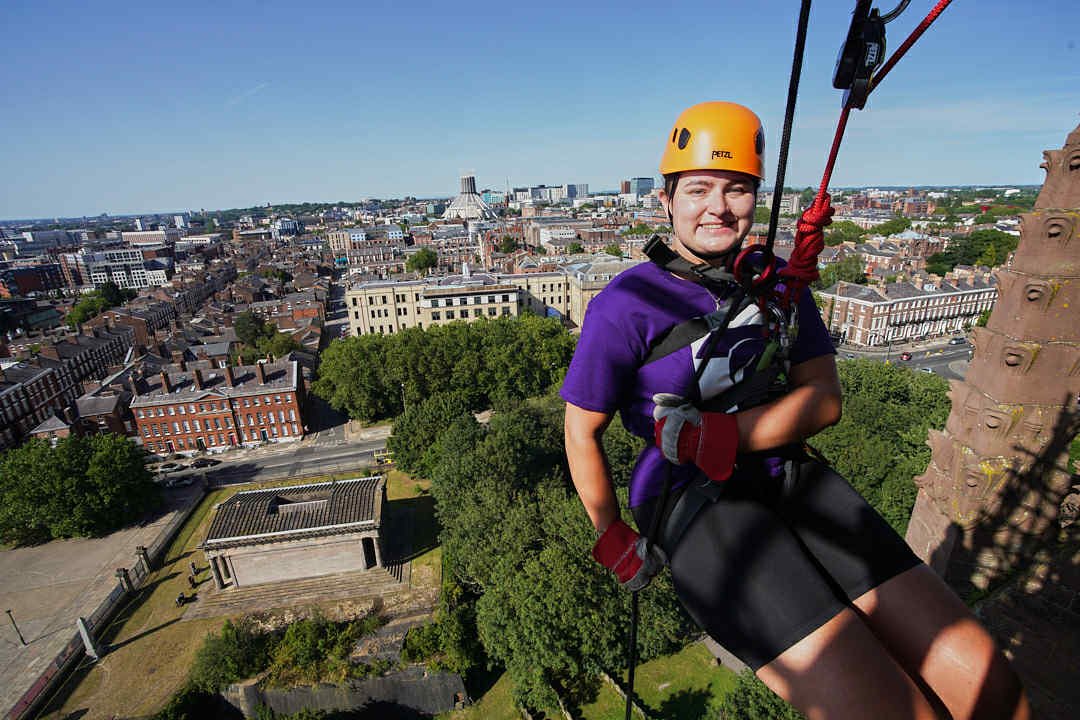 a halton housing colleague abseiling down liverpool cathedral