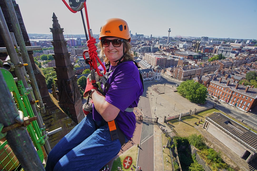 a halton housing colleague abseiling down liverpool cathedral