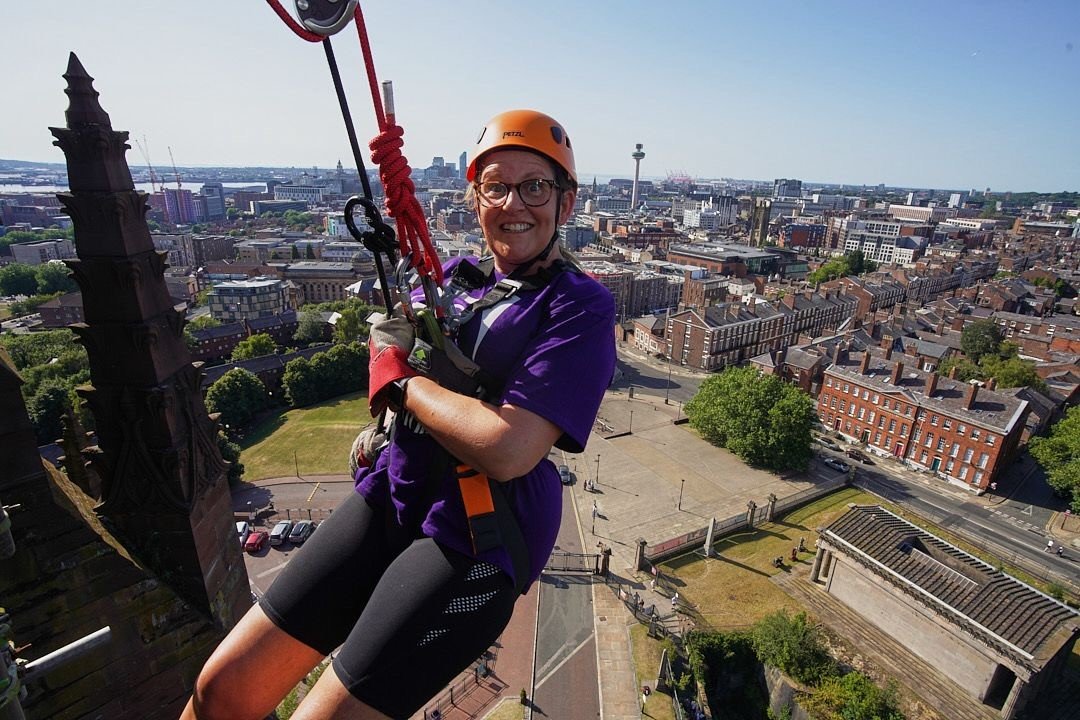 a halton housing colleague abseiling down liverpool cathedral